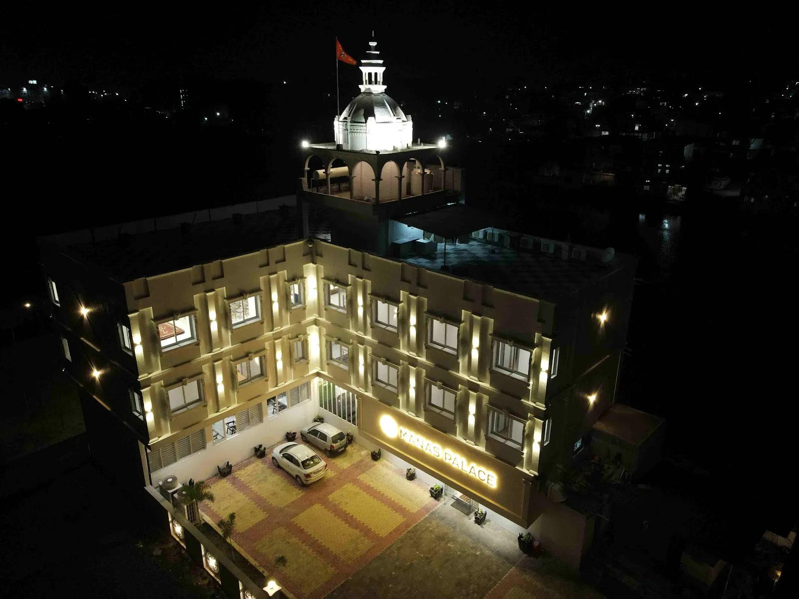 The entrance of Hotel Manas Palace at night