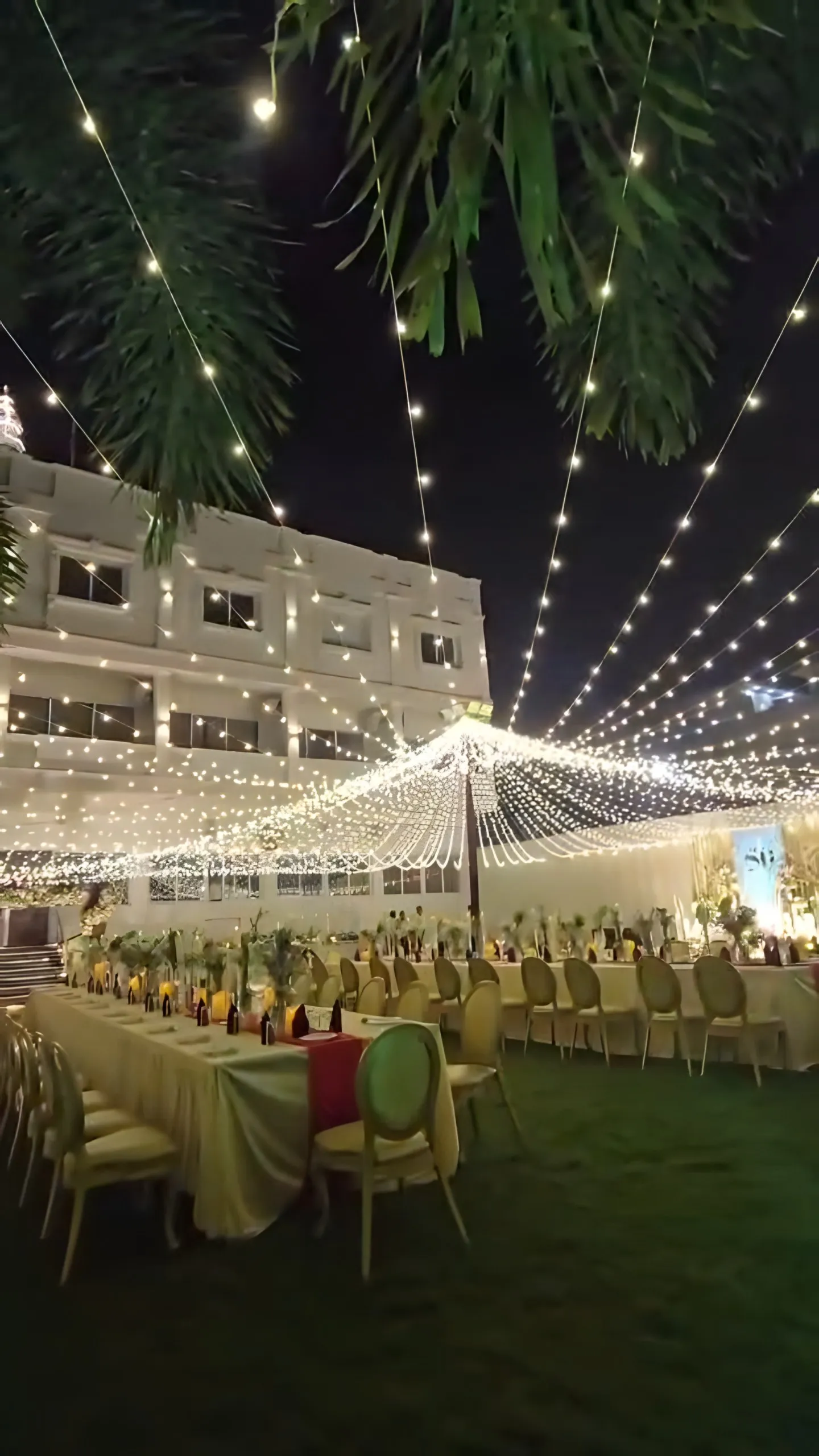 The hotel building behind the light canopy